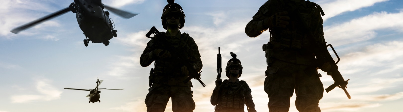 Silhouettes of soldiers during Military Mission at sunset